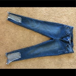 Blue jeans with ripped ankles